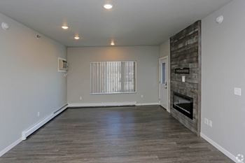 The living room with a fireplace in a bedroom plus den unit.